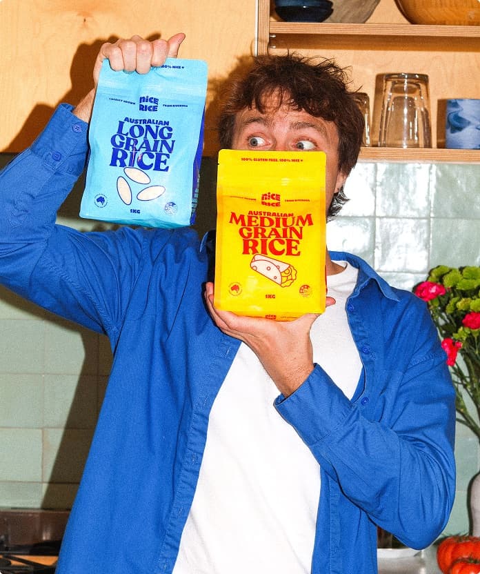 Appetise team member holding two bags of rice