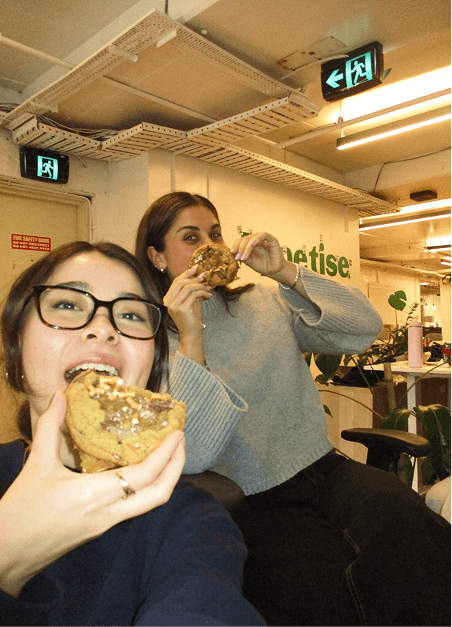 Two Appetise team members enjoying cookies in the office