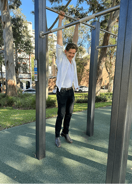Appetise team member hanging from playground bars
