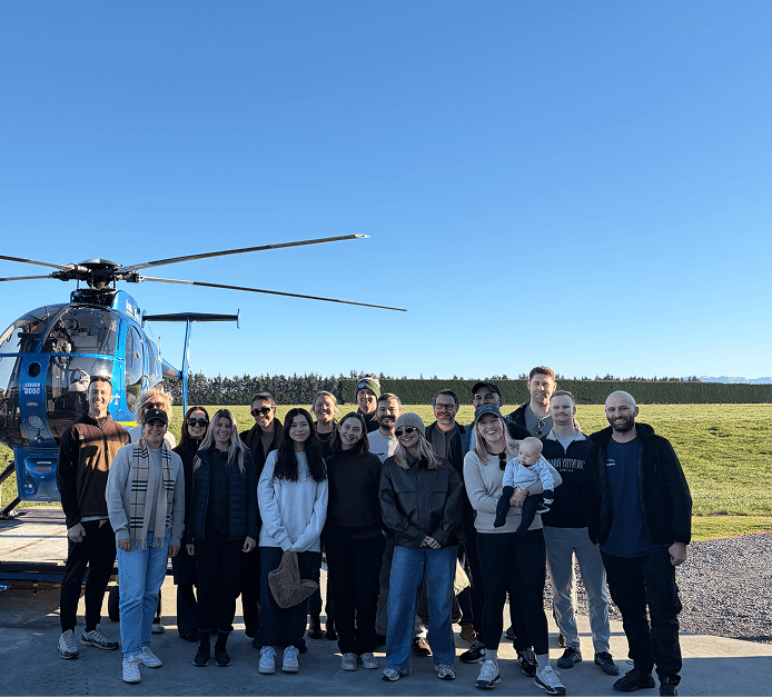 Appetise team gathered beside a helicopter